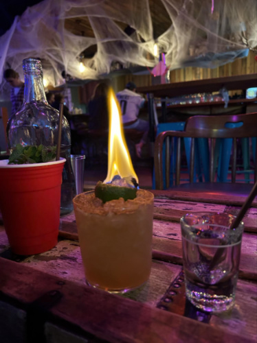 A glass of flaming cocktail in Belltown’s Navy Strength Bar