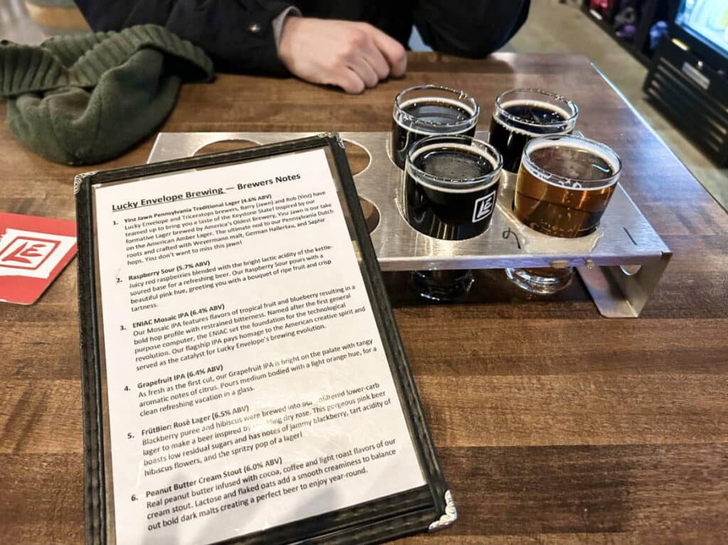 A flight of beer and the menu from Lucky Envelope Brewing