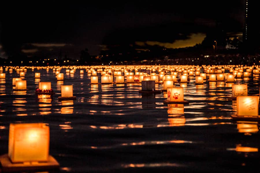 View of the illuminated floating lanterns on the water at night