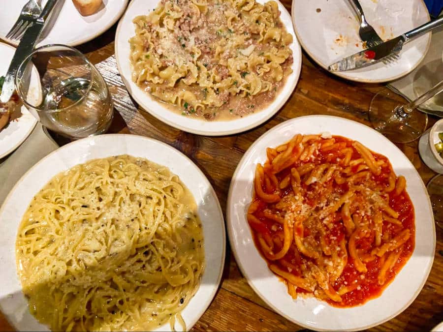 A plate of truffle taglierini, gigli (sausage pasta), and casarecce arrabiata at Flour & Grape