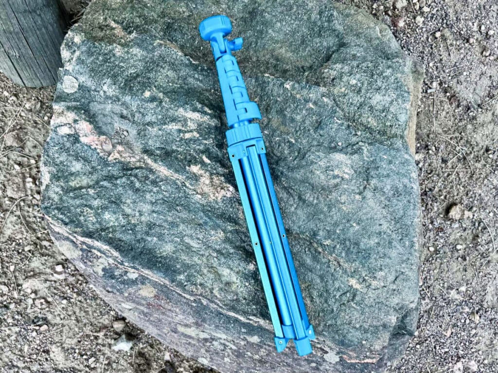 View of the folded length of Sensyne 62'' Phone Tripod on a huge rock