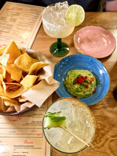 Closeup view of the margaritas, chips, and guac at Lady Nomada