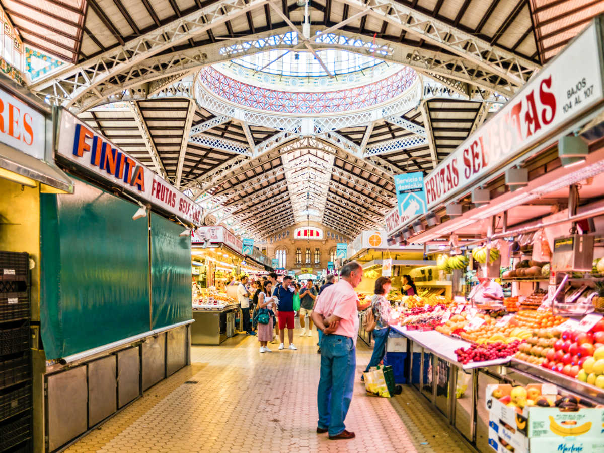 The people looking at the food stalls in The Central Market of Valencia