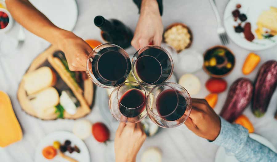 A group of people toasting with their glass of wine