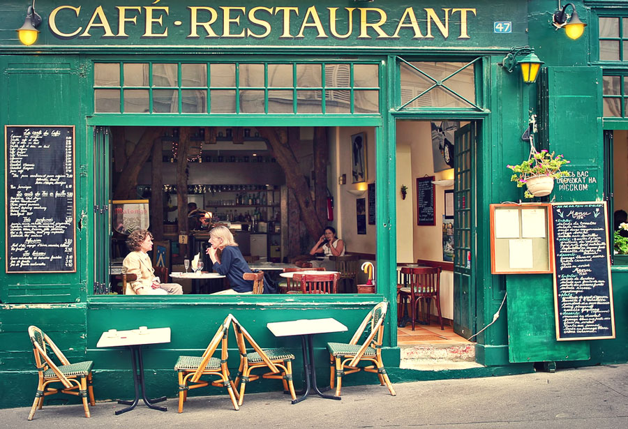 View of people dining in a green themed cafe and restaurant