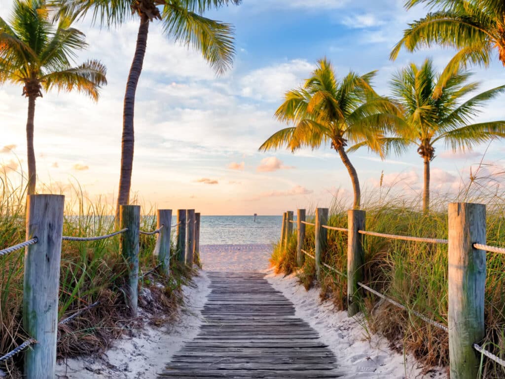 Scenic sunset view over the footbridge leading to Smathers Beach