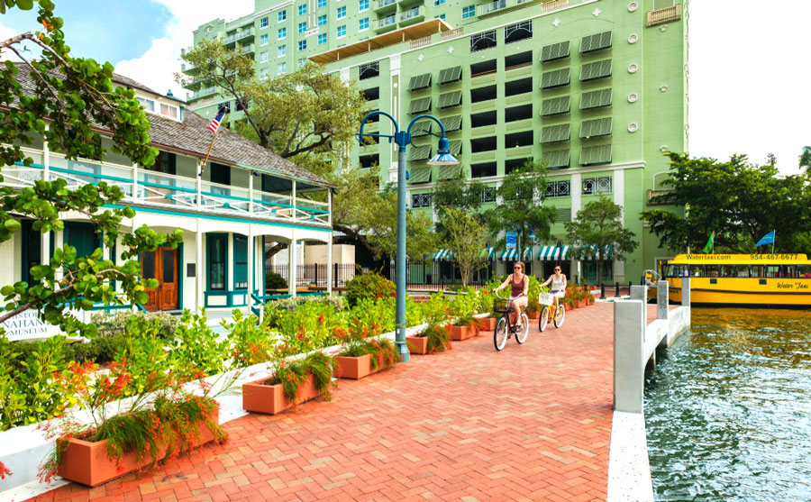 View of people riding a bike along the Las Olas Riverwalk