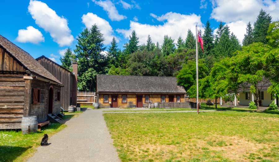 The clear blue sky and the green grass field in Fort Nisqually Living History Museum