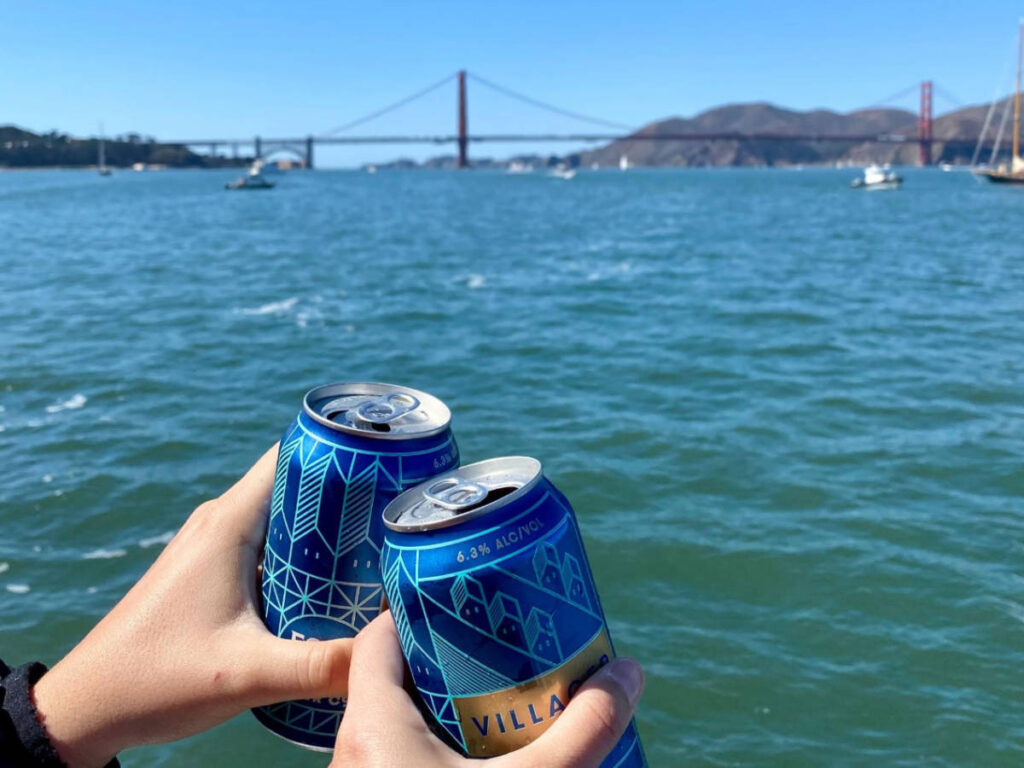 Hands holding a canned drink from Fort Point Brewing Co.