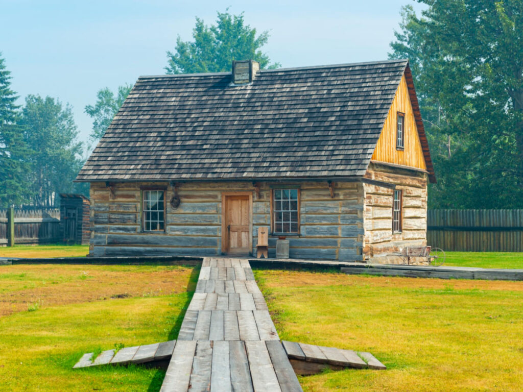 A charming wooden house with a rustic walkway at Fort St. James National Historic Site