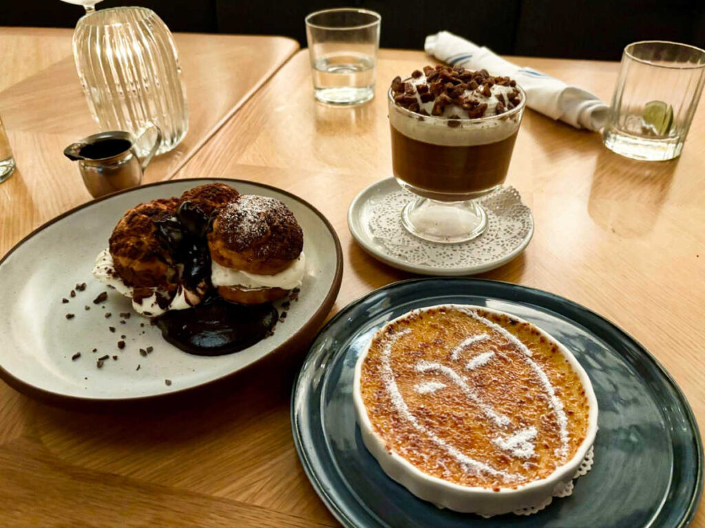 A table with pastries and dessert and a plate with Francine’s face on creme brulee