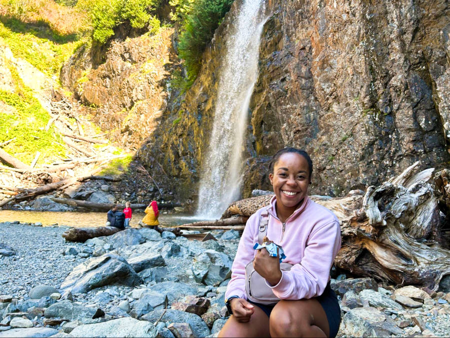 The author Chelsea Booker enjoying a snack near the plunge pool of Franklin Falls