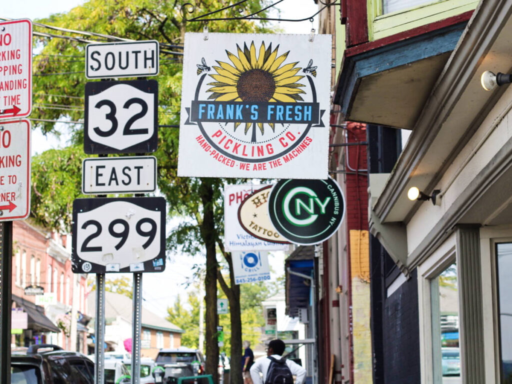 View of the traffic signages along with the Frank’s Fresh Pickling Co. sign