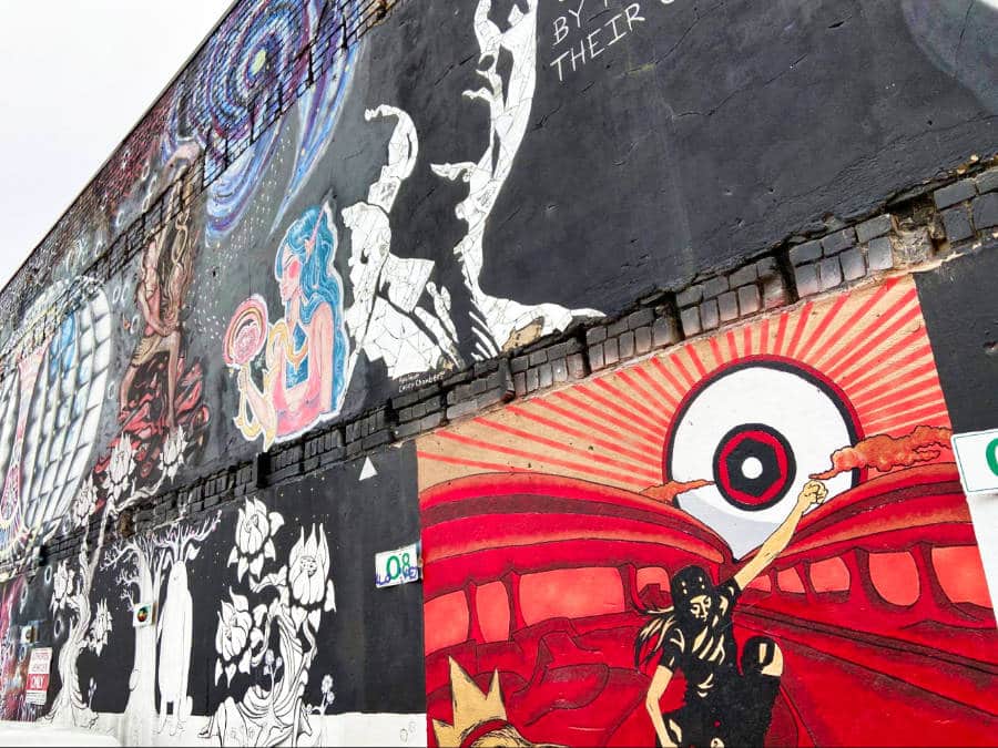 Collection of murals on a wall of the outdoor gallery of Freak Alley Gallery
