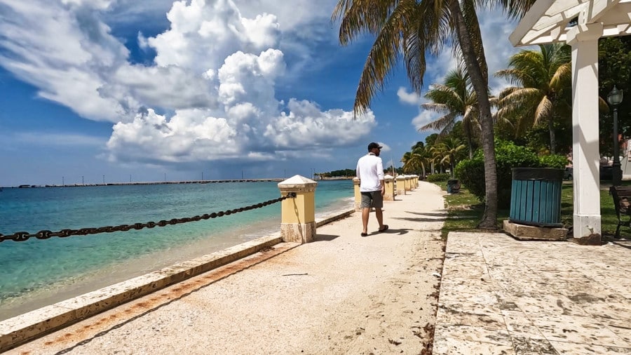 A man walking along the walkway and enjoying the view of Frederiksted
