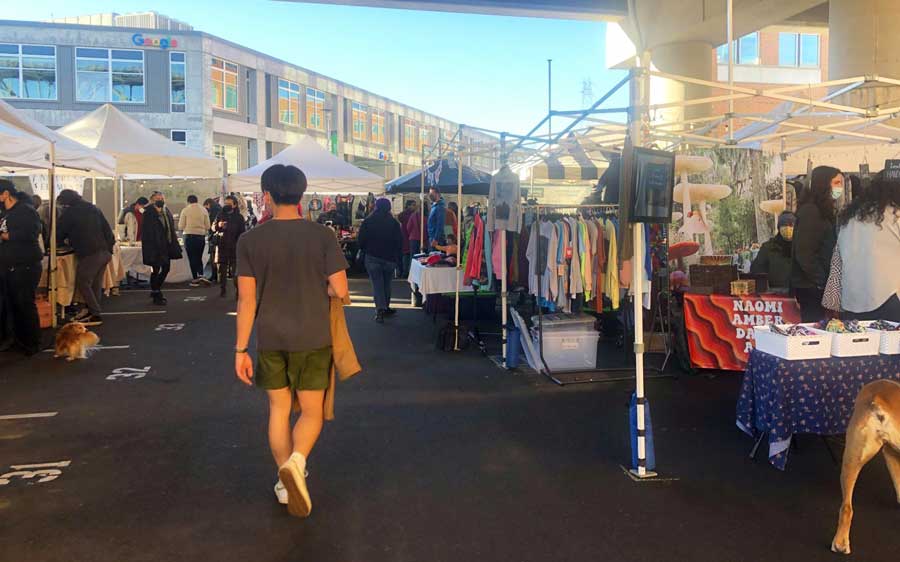 View of people and shops in Fremont Sunday Market in Seattle
