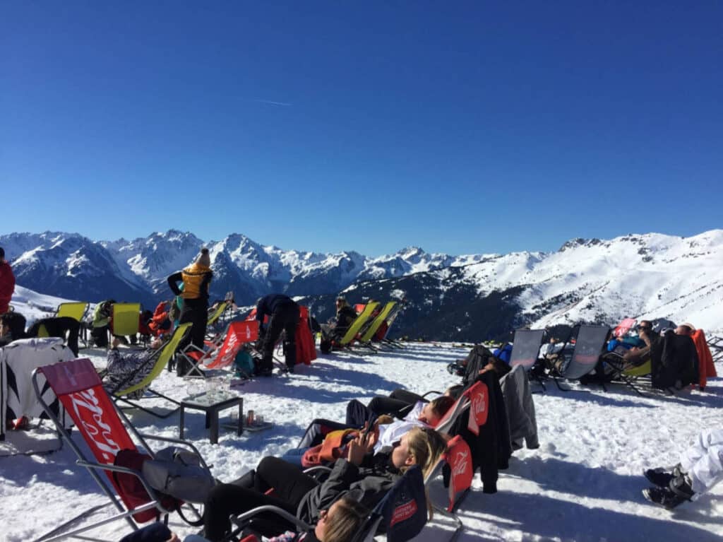 A group of friends having a rest during their ski trip at the French Alps