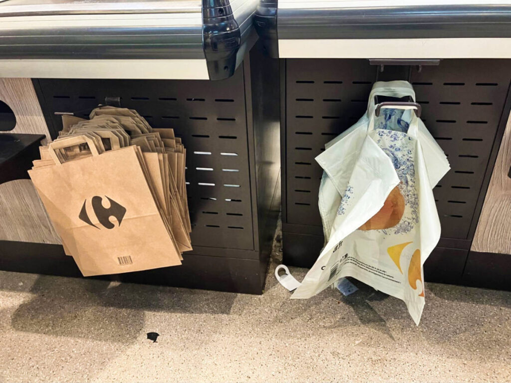 View of the variety of bags hung on the counters at a French grocery store