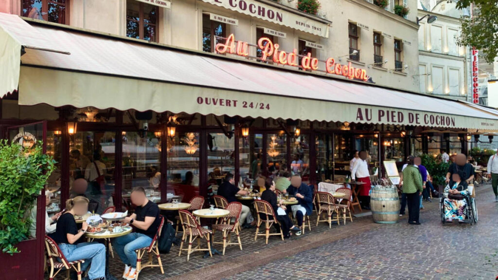 View of the people dining at the terrace of Au Pied de Cochon in Paris