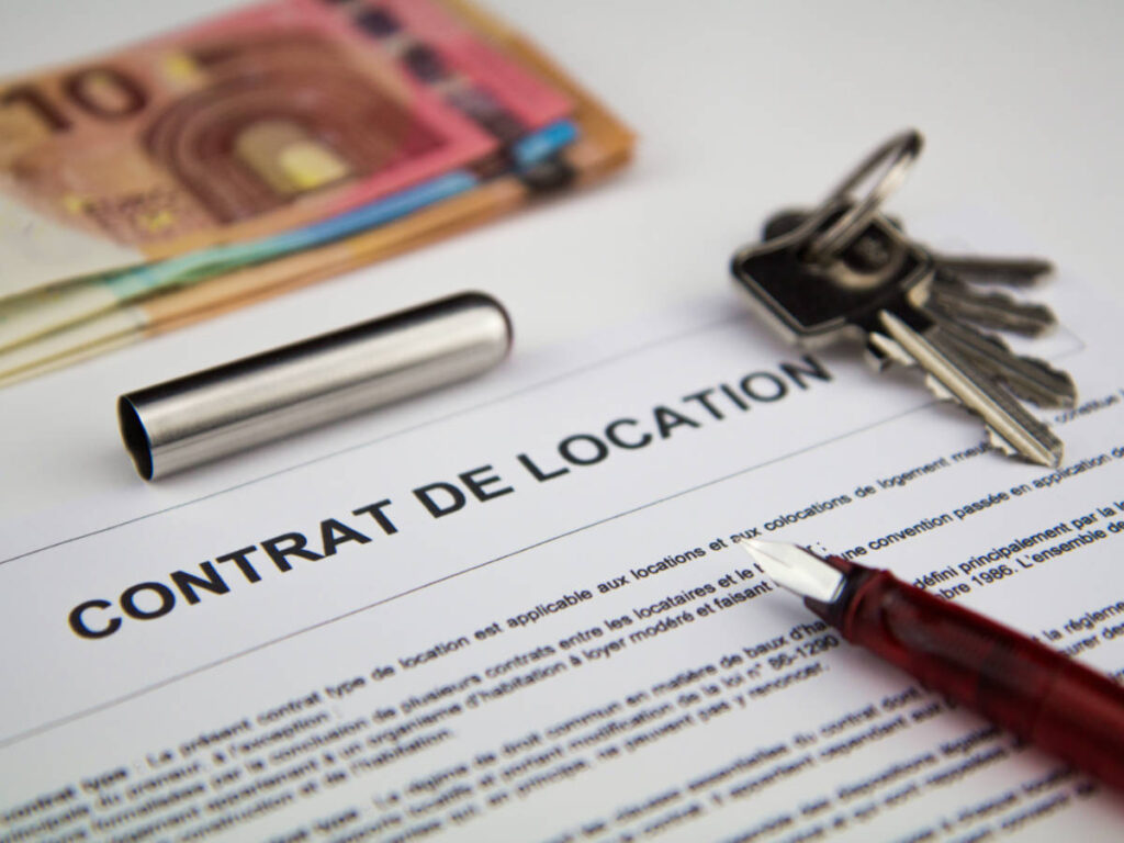 Closeup view of a French rental car contract with a pen and keys