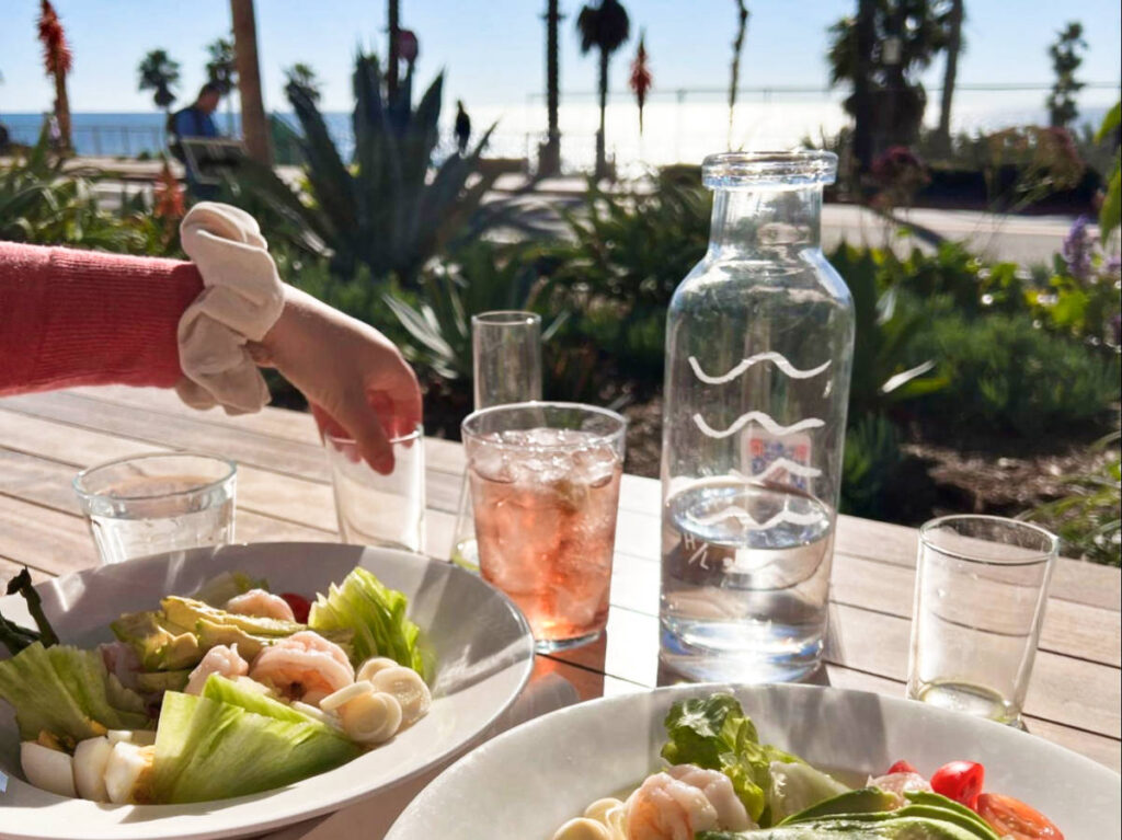 Two plates of fresh seafood salad with an ocean view in High/Low