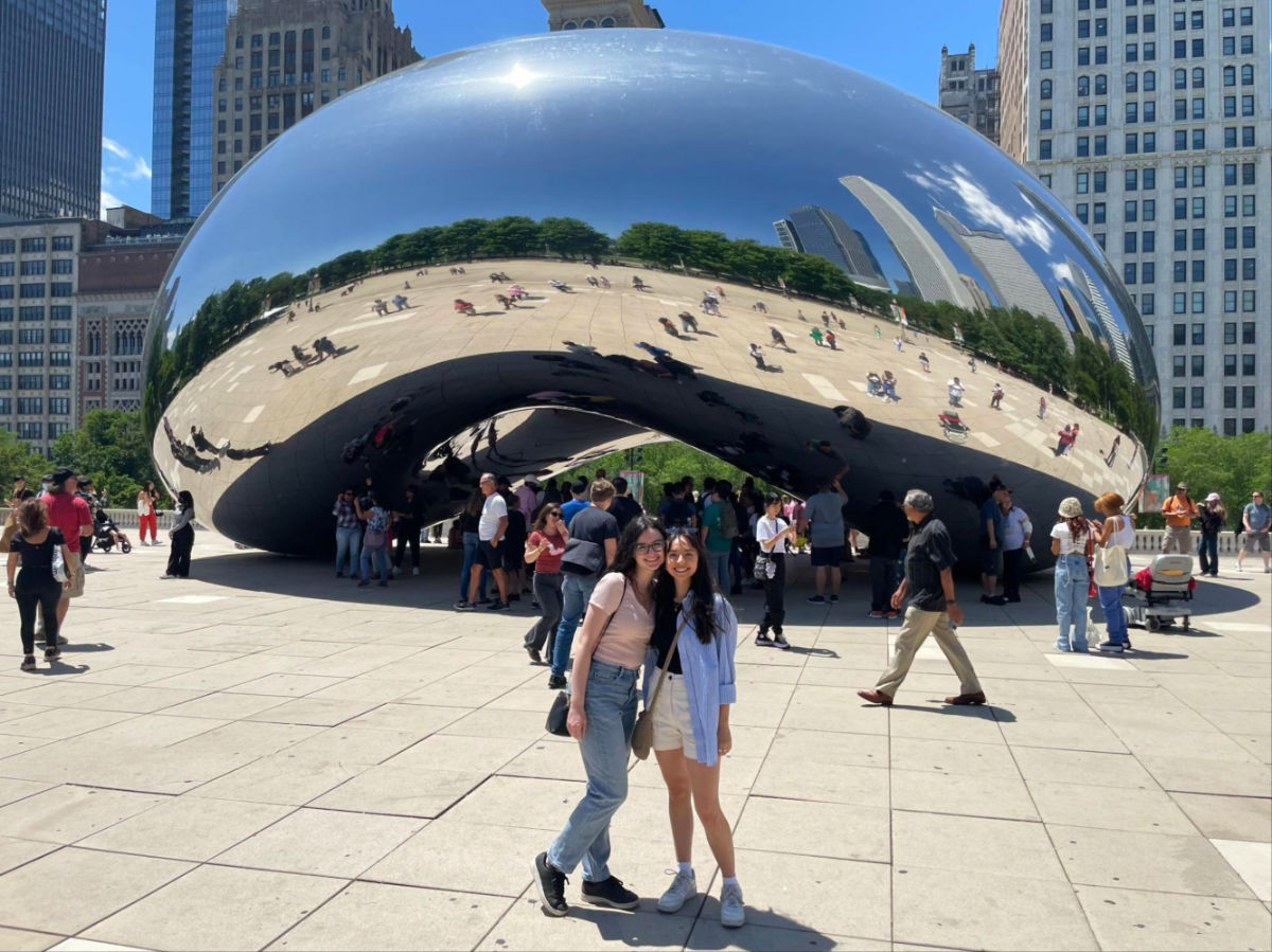 Author Lea Rose and her friend posing for a photo at the Cloud gate or The bean