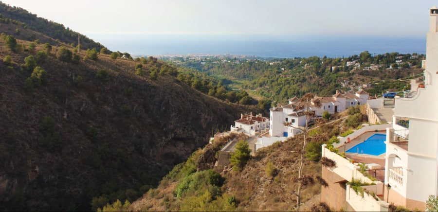 A small town above the mountain with a dreamy view of the landscape in Frigiliana.