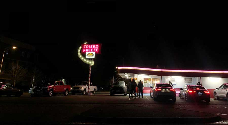 The illuminated Frisco Freeze sign at night