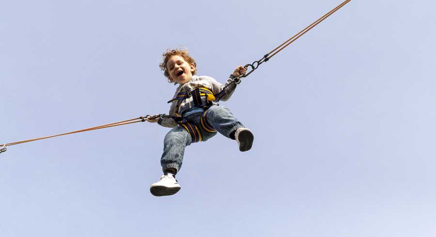 A boy having fun on a trampoline in Fun City