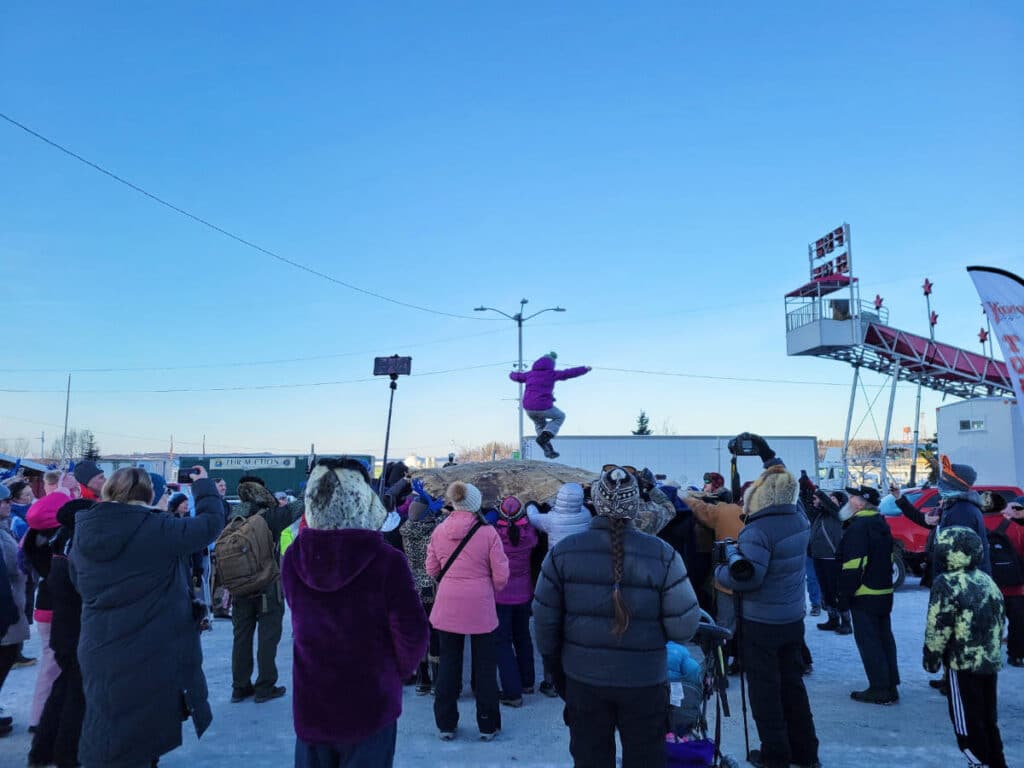 The traditional blanket toss during the Fur Rondy