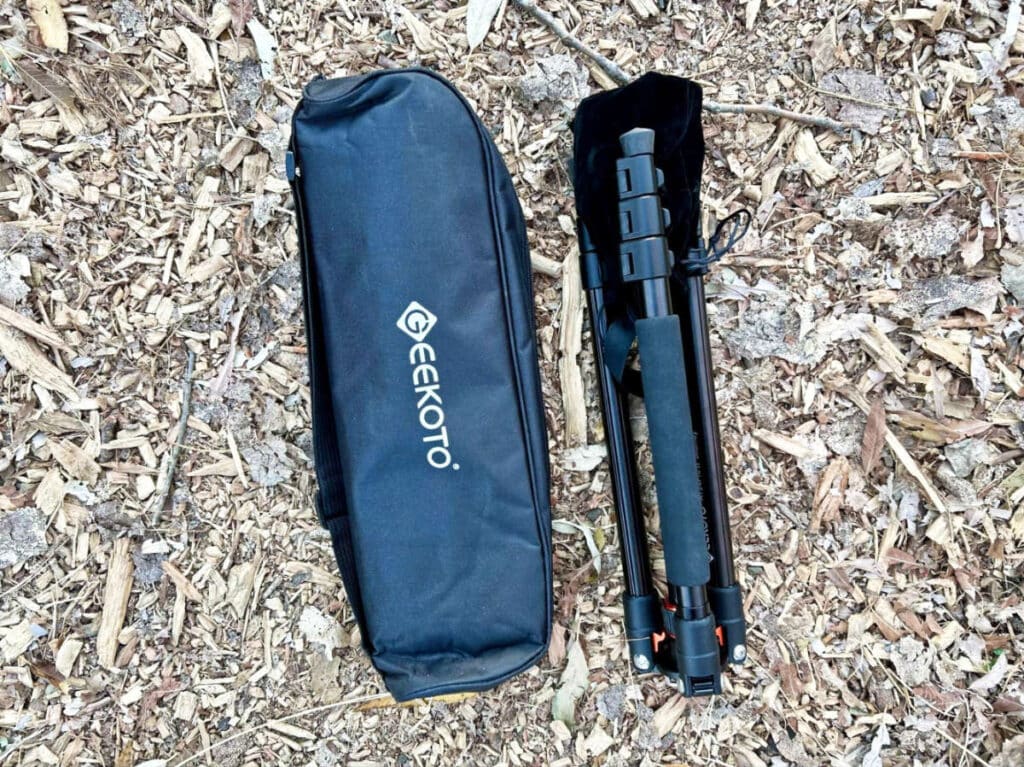 View of the folded length of GEEKOTO 77’’ Tripod and a drawstring bag