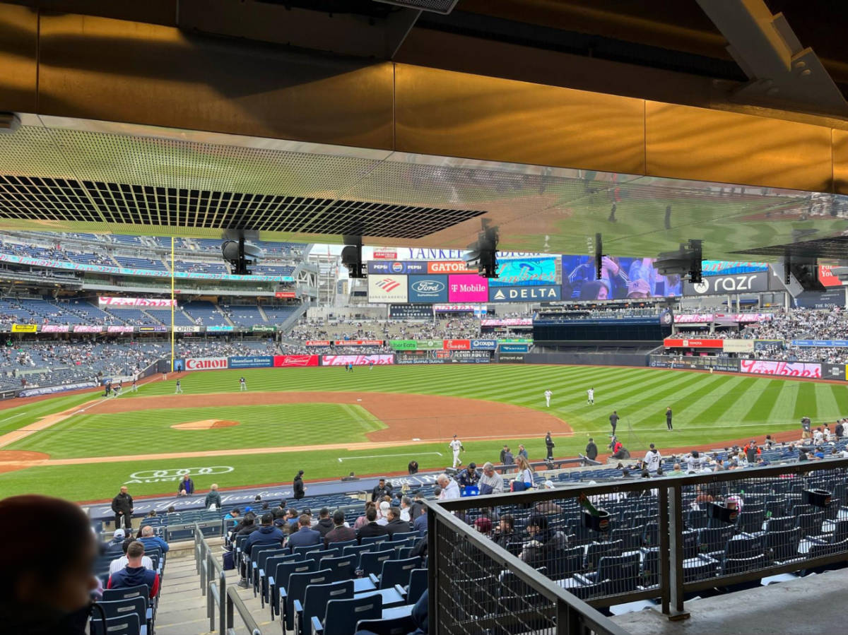 People watching a game from the bleachers in Yankee Stadium