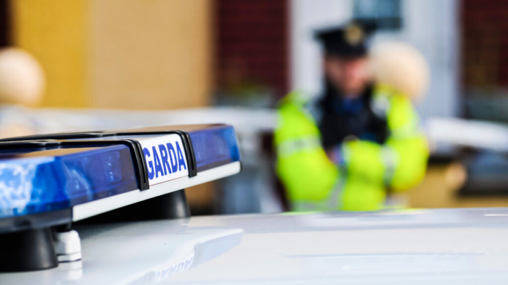 Closeup view of the police car with the blurry Irish police officer in the background