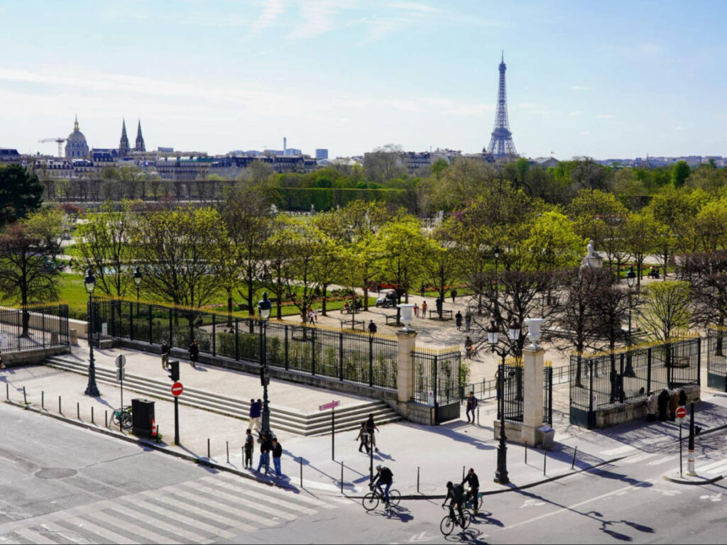 Overlooking view of the cyclists around a garden with the Eiffel Tower in the background