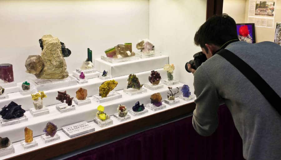 A photographer photographs the displayed rare gems at the Gem and Mineral Show