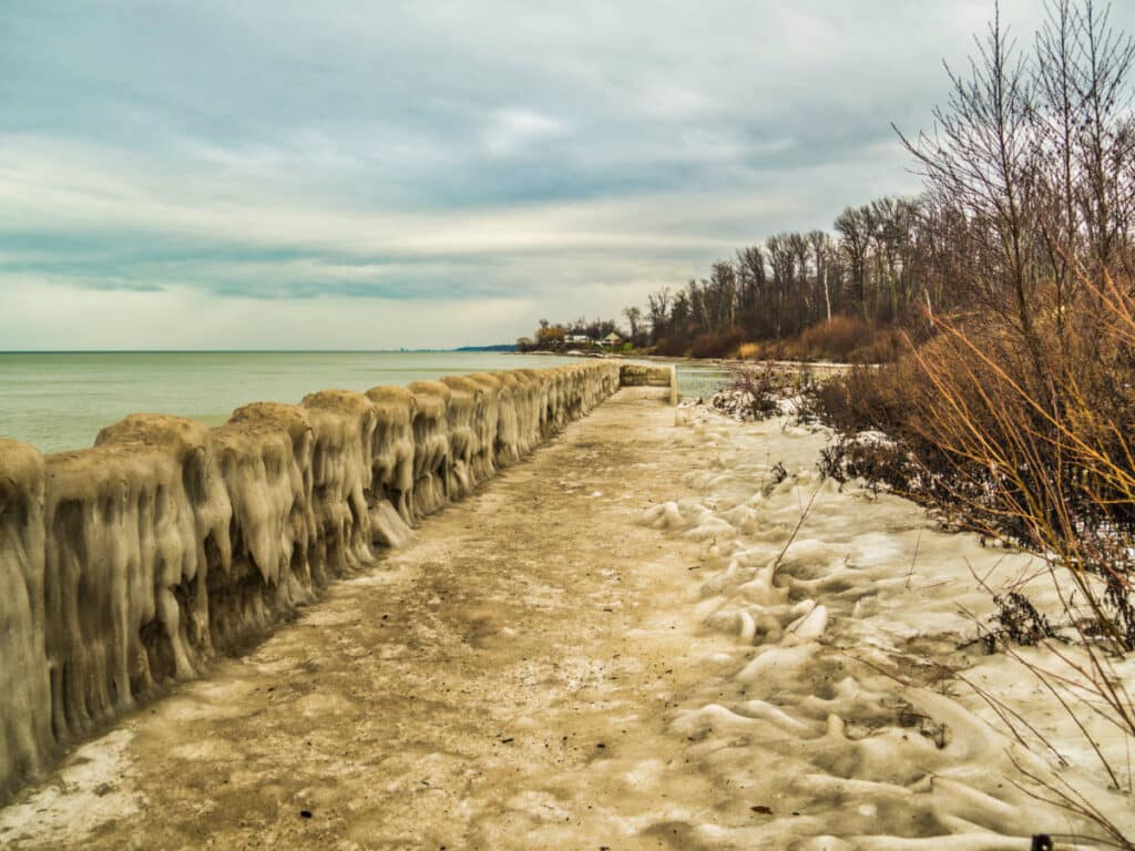 View of the fall foliage and the iced-over boardwalk at Geneva State Park