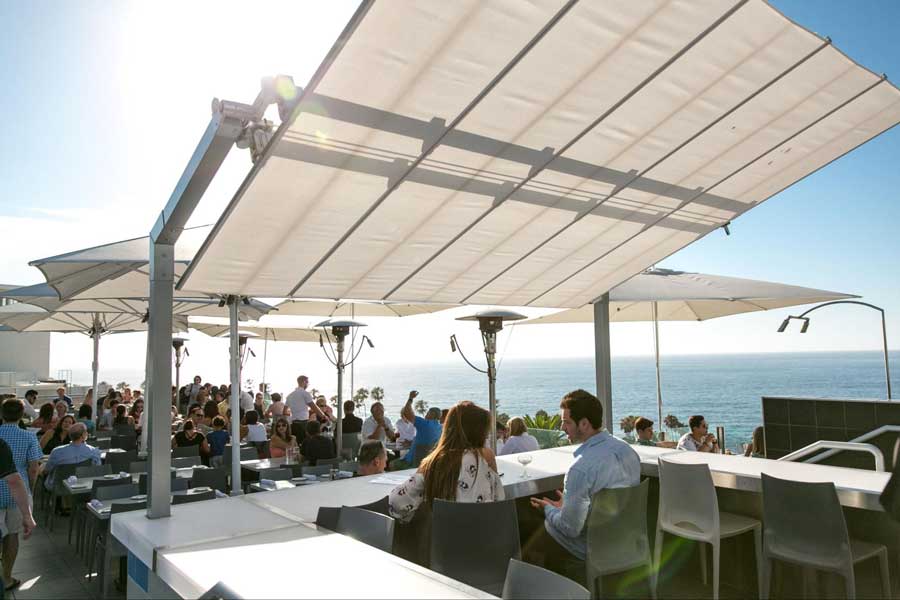 People enjoying their meal and view at the ocean terrace of George's at the Cove
