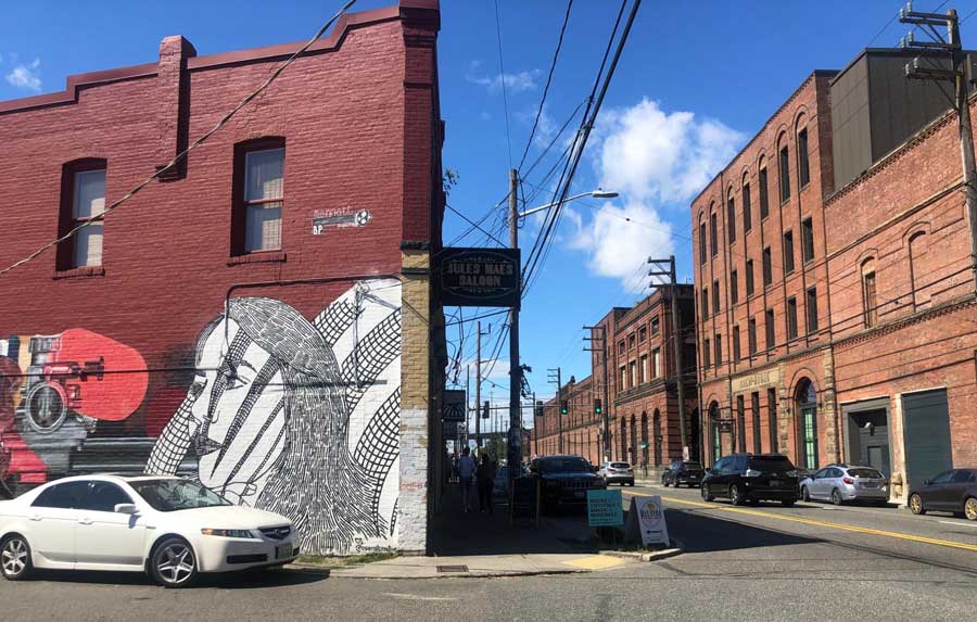 A mural on a building and cars parked on the neighborhood of Gerogetown