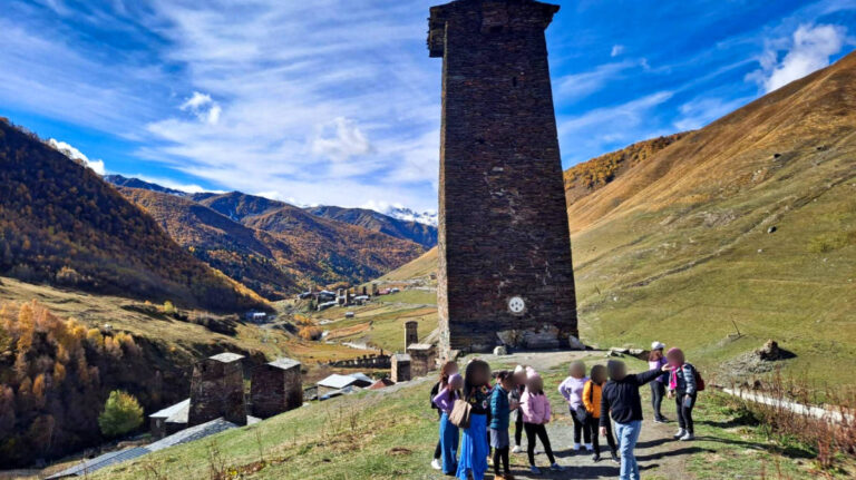 A group of tourists admiring the scenic mountain views in Mestia
