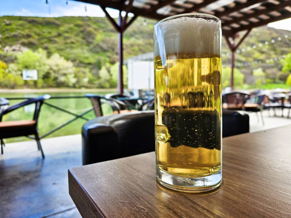 A glass of Georgian craft beer at an outdoor table