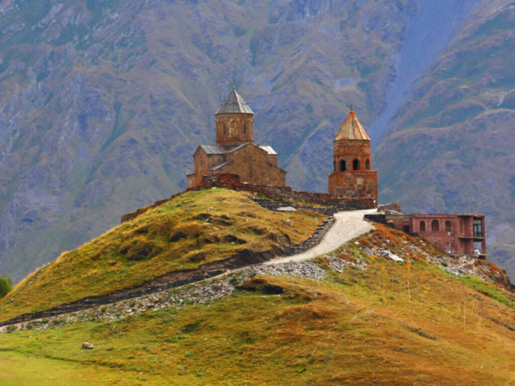 The Gergeti Trinity Church on top of the hill with the Kazbegi views in the background
