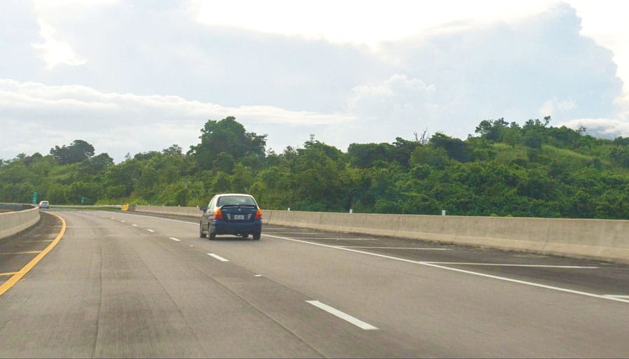 A black car driving around the highway of Puerto Rico
