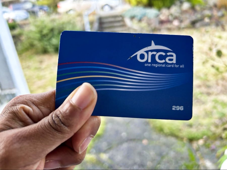 A closeup look at a hand holding an ORCA Card