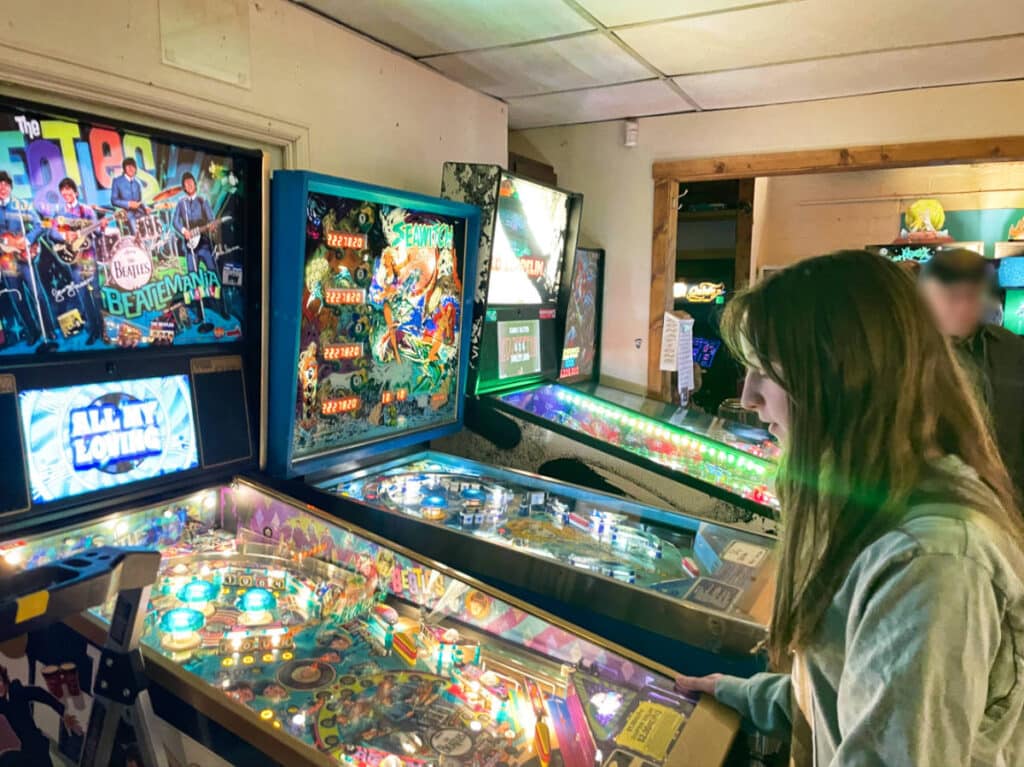 A girl playing the pinball machines at Lyons Classic Pinball