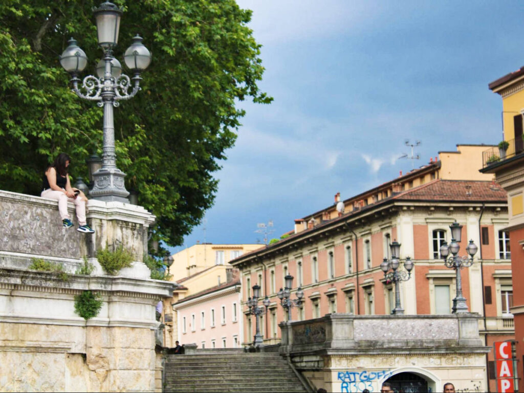A woman chilling on the wall in Parco della Montagnola