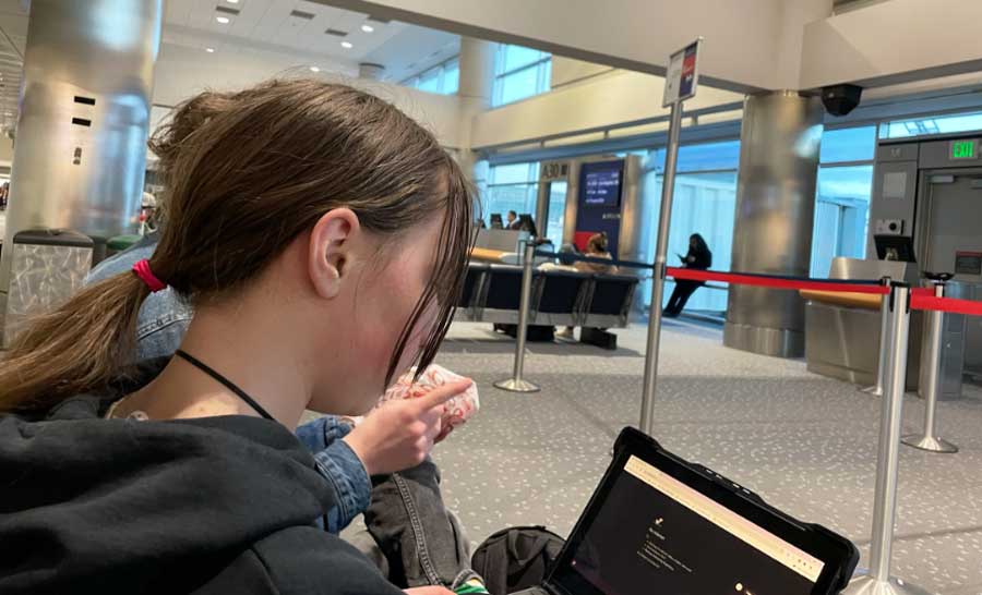The author's daughter using her gadget in an airport