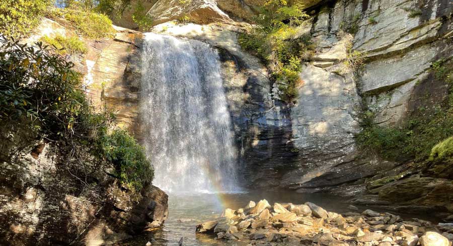 A small colorful rainbow formed at the bottom of Glass Falls