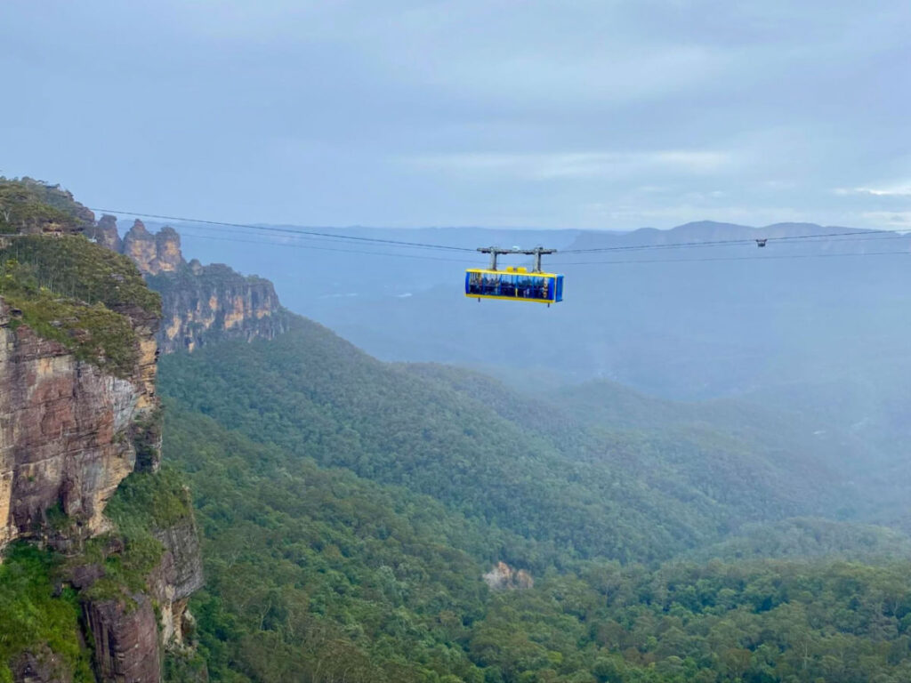 A glass-floor cable car gliding over the stunning Blue Mountains National Park