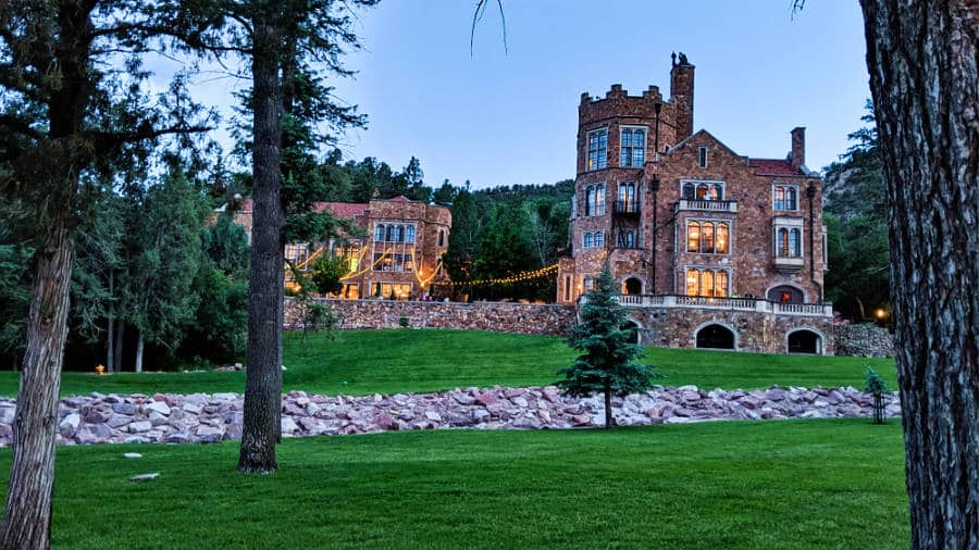 View of the Glen Eyrie Castle from the woods at dusk