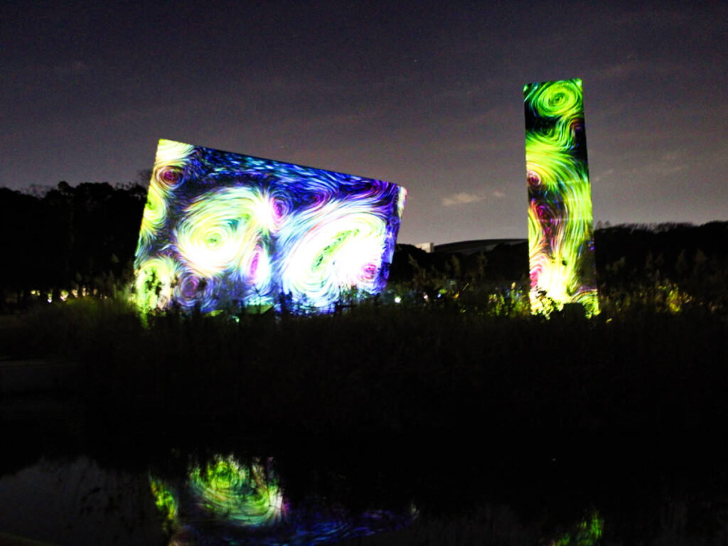 View of the illuminated art installation at TeamLab Botanical Garden at night